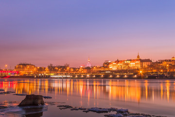Fototapeta premium Warsaw skyline with reflection in the Vistula river in the evening