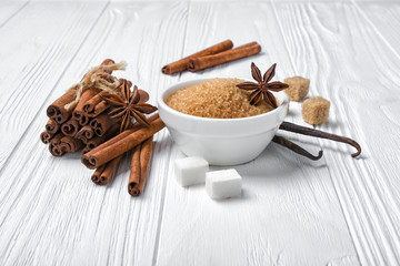 Brown cinnamon granulated and cane cubes sugar with different spices for confection