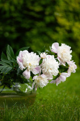 White peony bouquet in the round glass vase