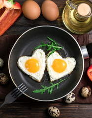 Breakfast: fried eggs with greens in a skillet