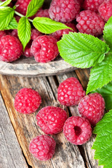 Fresh and tasty looking raspberries on  wooden table