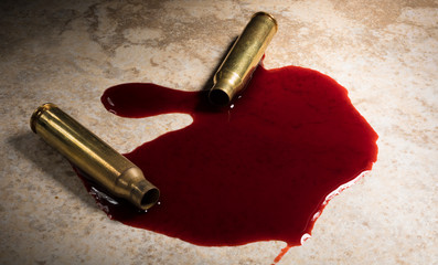 Spent AR-15 ammo and blood on the floor after a shooting has taken place