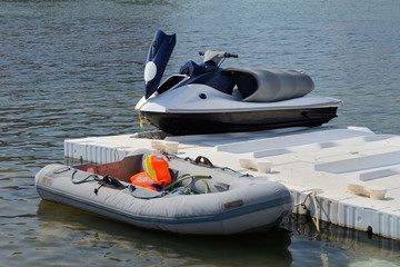 inflatable boat and jet ski on the dock