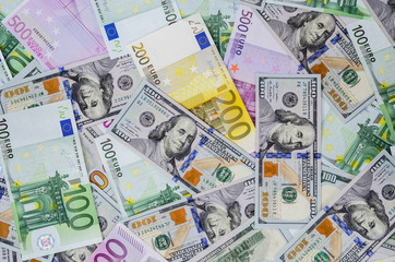 euro banknotes and dollars randomly laid out 2