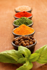 Herbs and spices on a wooden background
