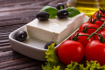 A piece of feta cheese on a wooden rustic background