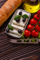 A piece of feta cheese on a wooden rustic background