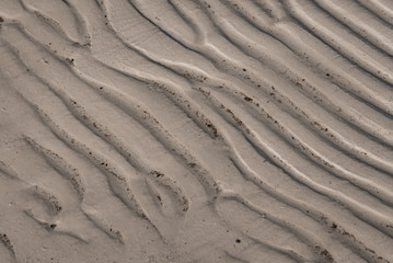 Close up of corrugated ridges left in beach sand by the retreating ocean tide.