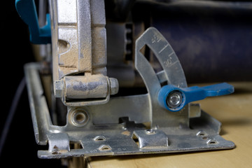 Circular saw on a workshop table. Tools for a carpenter in a home workshop.