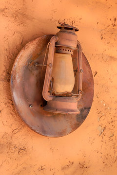 Old Oil lamp hanging on the wall of a building at the Old Tucson Film Studios amusement park in Arizona