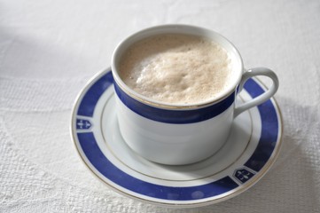 cappuccino italian breakfast cup of coffee on wooden table
