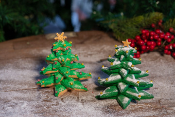 Various Christmas sweet colorful cookies with christmas tree on wood table