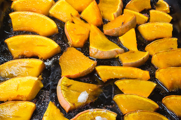 Homemade fried pumpkin, with seeds and bread on pan.