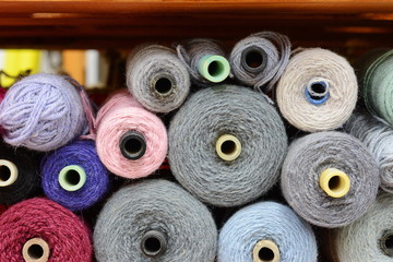 Background with a lot of colorful coils with yarn . Beautiful yarn knitting background. Close up of...