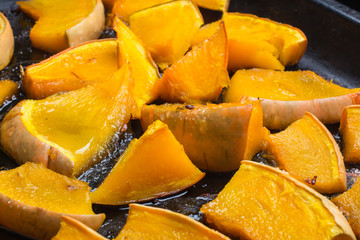Homemade fried pumpkin, with seeds and bread on pan.