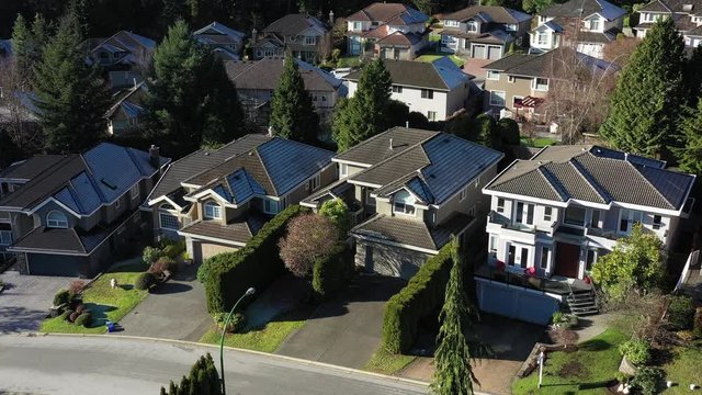 A perfect neighbourhood. Houses in suburb at Summer in the north America. Luxury houses with nice landscape. Aerial drone view.