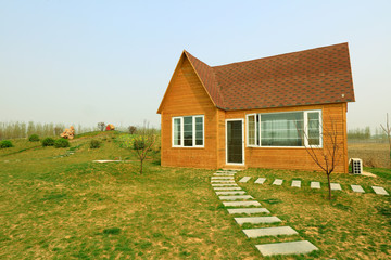 Fototapeta premium wooden house and stone path