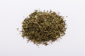 dried tarragon and essential oil on a white background