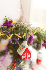 Blurred christmas background. The branch of the Christmas tree decorated with Christmas toys. Selective focus, blur bokeh.