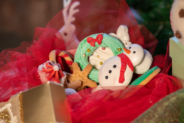 Various Christmas sweet colorful cookies with christmas tree on wood table