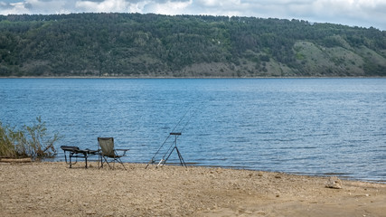 Fototapeta na wymiar Relaxing fishing on the river near forest