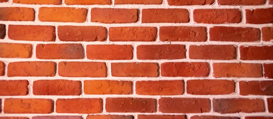 Weathered texture of stained old dark brown and red brick wall background, grungy rusty blocks of stone-work technology, colorful horizontal architecture.