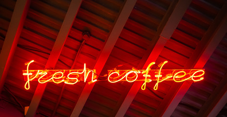 Red neon sign fresh coffee. Abstract hipster background.