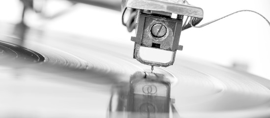 The old dusty vinyl turntable player over white