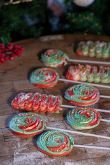 Naklejka premium Various Christmas sweets and candies with christmas tree on wood table