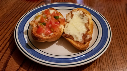 Mollete, delicious typical Mexican food. Sliced bread roll bolillo with refried beans, melted cheese and pico de gallo.