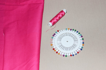 Pink fabric and thread.