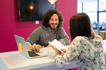 Startup young workers sitting at the table with a laptop computer.