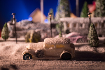Miniature of winter scene with Christmas houses, train station, trees, covered in snow. Nights scene. New year or Christmas concept.