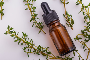 essential oil of thyme on a white background