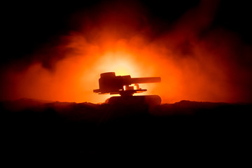 War Concept. Military silhouettes fighting scene on war fog sky background, World War German Tanks Silhouettes Below Cloudy Skyline At night. Attack scene. Armored vehicles. Tanks battle