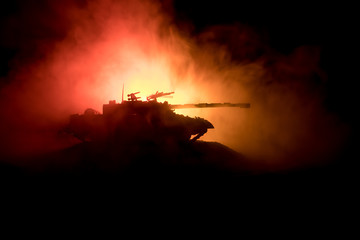 War Concept. Military silhouettes fighting scene on war fog sky background, World War German Tanks Silhouettes Below Cloudy Skyline At night. Attack scene. Armored vehicles. Tanks battle