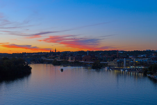 Fototapeta Beautiful sunset over Georgetown waterfront, Washington DC, USA. US capital panorama near Potomac River.