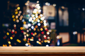 Wood table top on blur Christmas tree background.