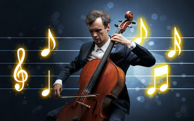 Young handsome cellist playing with music sheet background