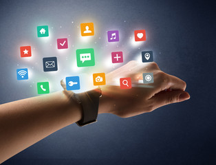 Naked female hand with smartwatch and  application labels around and dark background