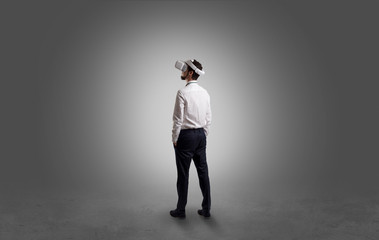 Fototapeta premium Businessman wearing vj glasse in an empty room with no wallpaper