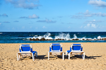 Pristine Caribbean beach with beach chairs
