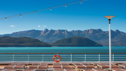 Empty cruise ship lounge chairs and life ring, Lido Deck. Alaska, USA.