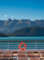 Empty cruise ship lounge chairs and life ring, Lido Deck. Alaska, USA.