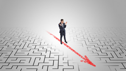 Businessman going through the maze with red arrow
