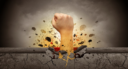 Obraz premium Big hand hits intense and breaks a crass stonewall 