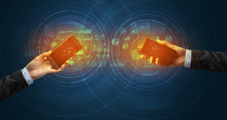 Close up of two smartphones syncing business data