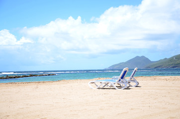 Fototapeta na wymiar Pristine Caribbean beach with beach chairs 