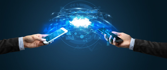 Two mobile phones syncing through the cloud