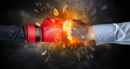 Naklejka premium Two hands fighting and breaking a rock into small pieces 